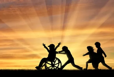 Young Children Playing with Child in Wheelchair