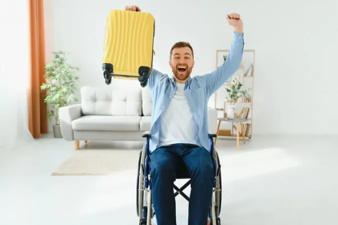 happy person on a wheelchair with his luggage