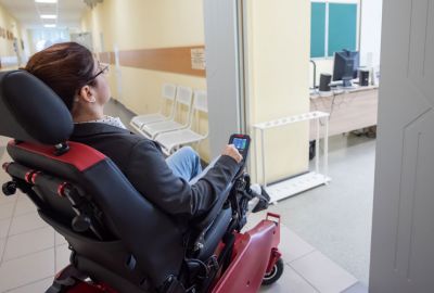 woman on power chair in a hospital