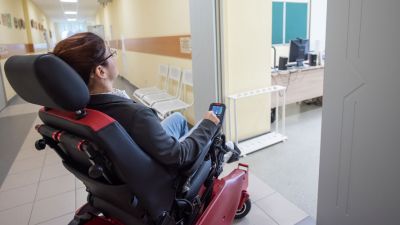 woman on power chair in a hospital