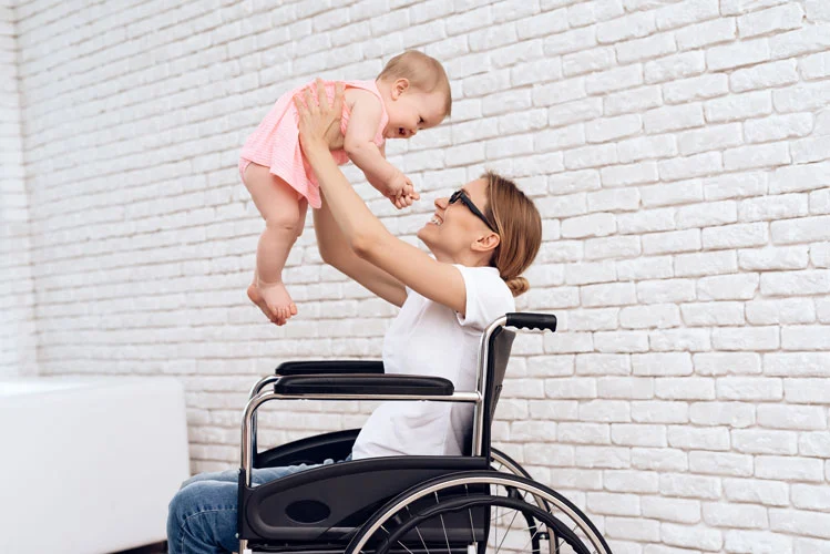 mother on a wheelchair with her baby