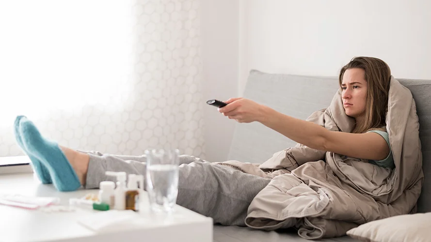 Sleep Better with Multiple Sclerosis - Woman in Bed Watching TV