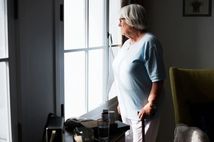 woman standing against a window