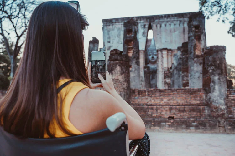 a woman clicking picture of a monument