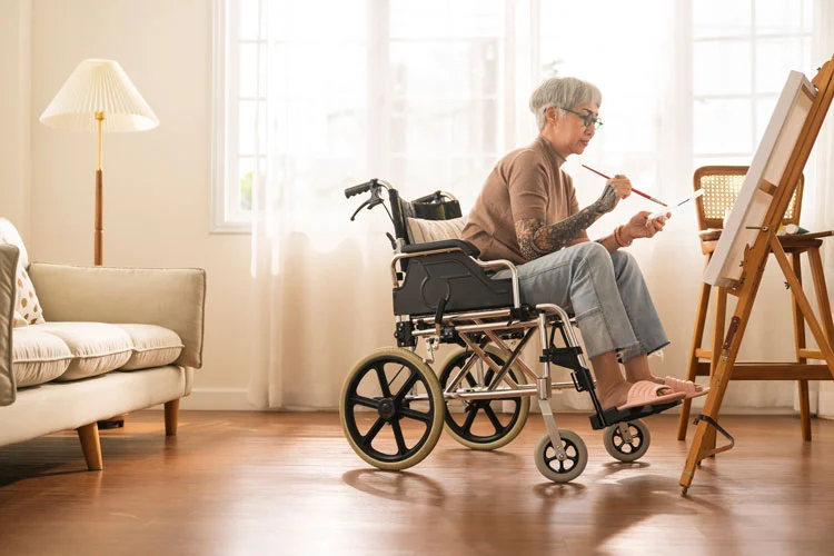 a woman on wheelchair doing art