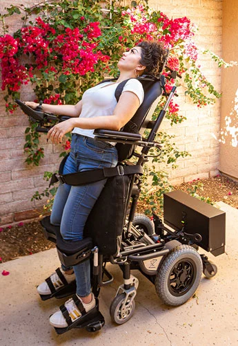 standing power chair user doing stretching exercise 